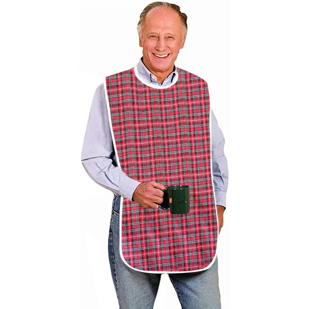 An older man wearing a red and black plaid waterproof mealtime bib over a light blue shirt.