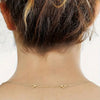 A close-up of an adjustable lobster clasp necklace chain worn around the neck.