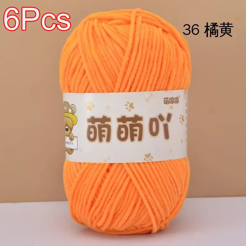 A ball of bright orange chenille yarn labeled with Chinese characters and a quantity indicator.