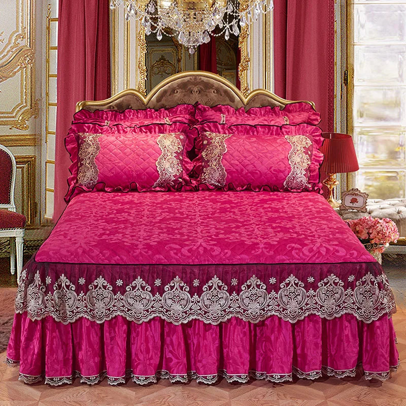 A vibrant pink satin bed skirt set featuring a ruffled hem and matching pillowcases on a bed.