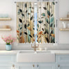 Light green abstract leaf print curtains hanging in a window with white vanity below