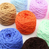 A collection of brightly colored chunky velvet knitting yarn skeins in shades of orange, purple, blue, and green.