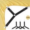 A set of four black adjustable triangle bed sheet clips used to secure bedding.