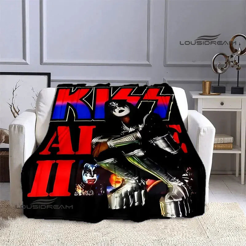 A black printed flannel travel blanket featuring a graphic design of a masked figure with metallic armor and glowing eyes.