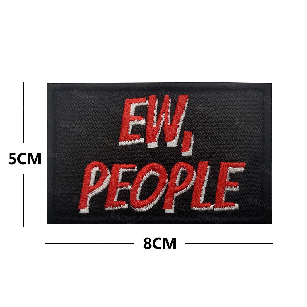 Black embroidered patch with red text EW, PEOPLE and dimensions 5cm by 8cm