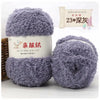 A pair of fluffy purple coral velvet yarn balls for crafting displayed next to a label.
