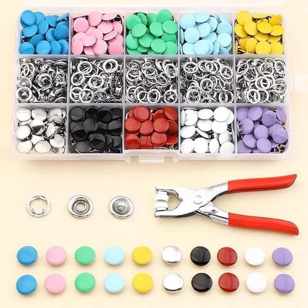A collection of colorful metal sewing buttons in various shades and sizes arranged in a plastic kit.