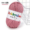 A skein of pink craft yarn labeled Hobbytime for knitting and crochet
