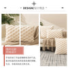 A set of cream-colored decorative plush pillow covers displayed on a sofa with natural light and greenery.