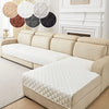 A beige sofa cushion cover with a quilted white fabric is displayed on a light-colored sofa.