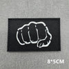 Black tactical patch featuring a white clenched fist design