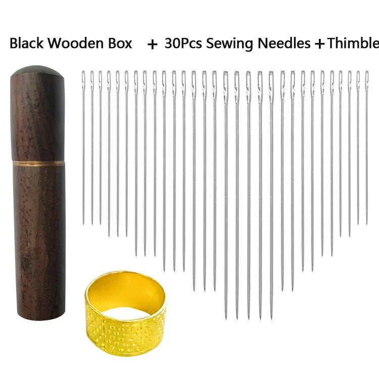 A black wooden box containing 30 sewing needles and a gold thimble.