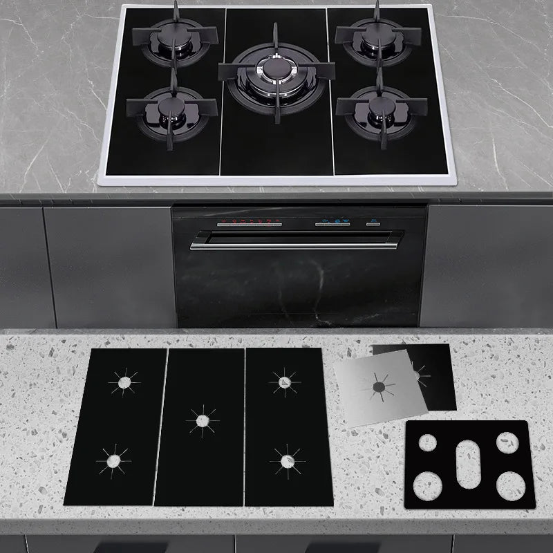 A set of black gas stove protectors and a built-in oven unit installed in a kitchen countertop.