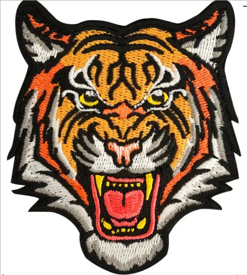 An embroidered patch featuring a fierce orange and black tiger head with yellow eyes.