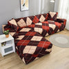 A stylish printed sofa protector cover featuring a red and brown plaid pattern on a dark fabric.
