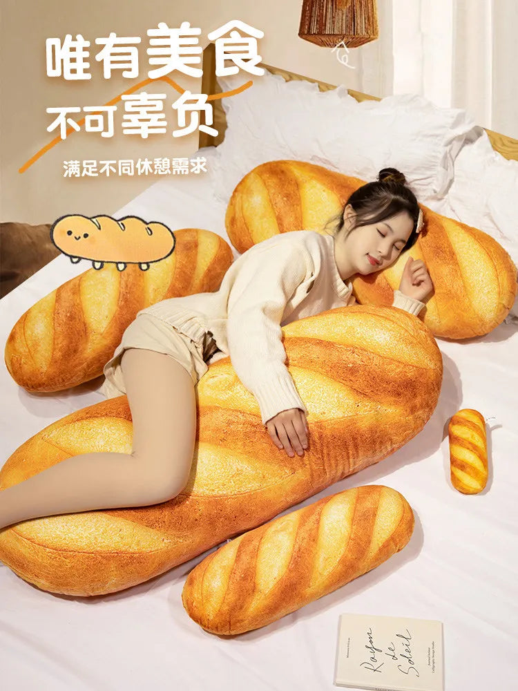 A soft plush yellow baguette shaped pillow is shown resting on white bedding.