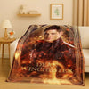 A large print featuring Dean Winchester with a fiery background and his name on an orange-toned flannel throw blanket.