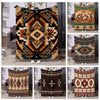 A collection of soft flannel throw blankets featuring various ethnic and geometric patterns in earthy tones.