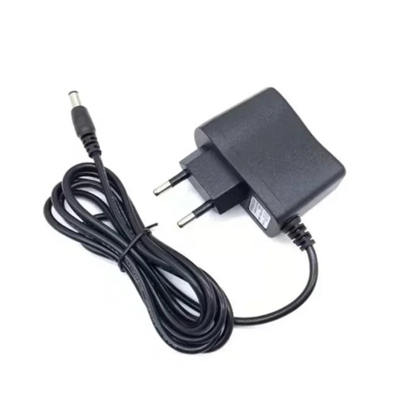 Black portable handheld sewing machine with an attached power cord and adapter.