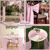 Pink gauze runner draped over a table and used as a backdrop for rustic boho decor