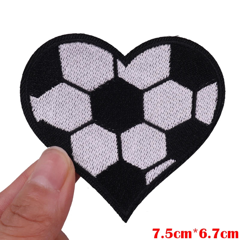 Black heart shaped patch embroidered with a white soccer ball pattern