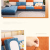 A modern sectional sofa featuring orange and blue upholstery with light cream cushions and a neutral gray rug.