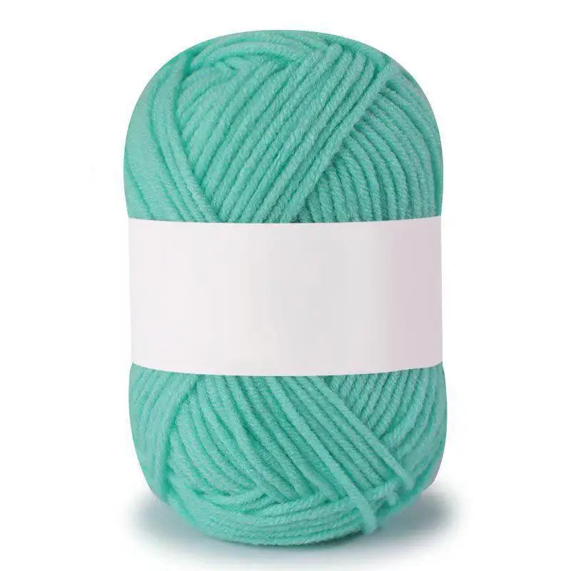 A ball of teal green soft milk cotton knitting yarn