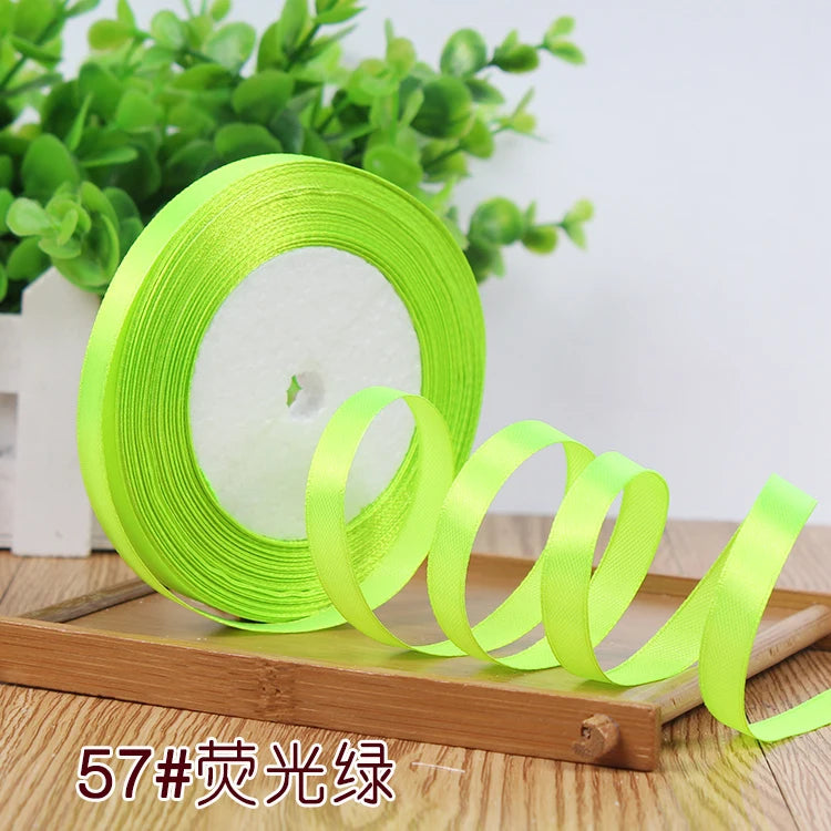 Roll of bright lime green satin ribbon used for crafting or decoration
