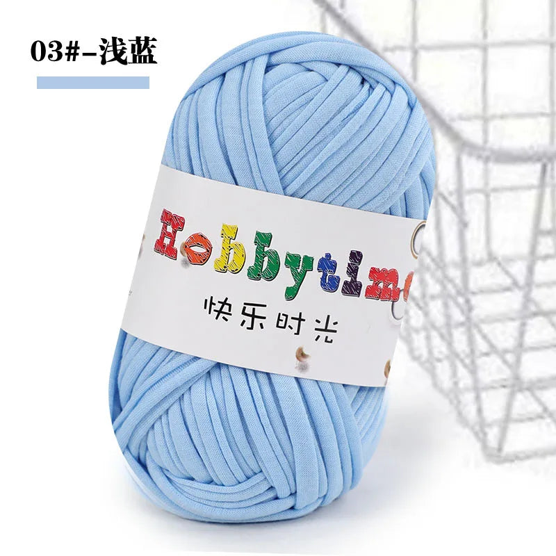 A ball of light blue thick polyester craft yarn labeled Hobbytime with Chinese text for knitting and crochet