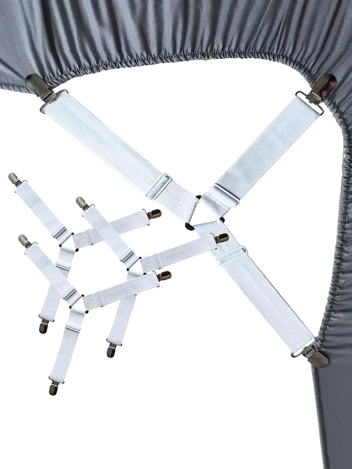 Adjustable sheet corner grippers with elastic straps used to secure bedding.