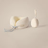 A beige U-shaped memory foam travel neck pillow with a cooling cover and strap is shown on a light background.