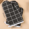 A pair of black and white checkered heat-resistant kitchen oven gloves shown flat with measurements.