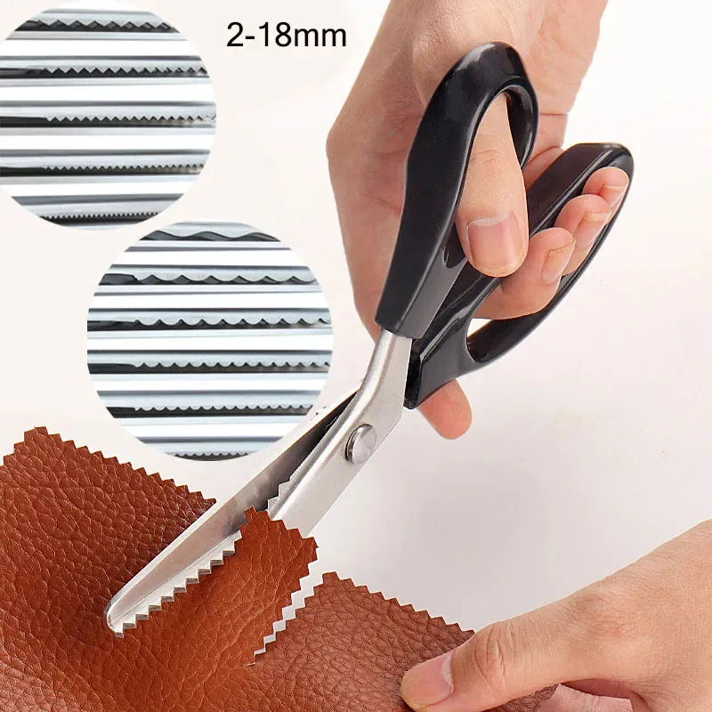 A pair of stainless steel zig zag lace sewing scissors is shown cutting brown leather material.