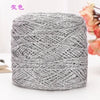 A ball of metallic silver silk yarn used for crocheting and knitting.