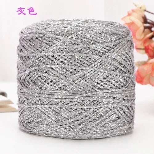 A ball of metallic silver silk yarn used for crocheting and knitting.