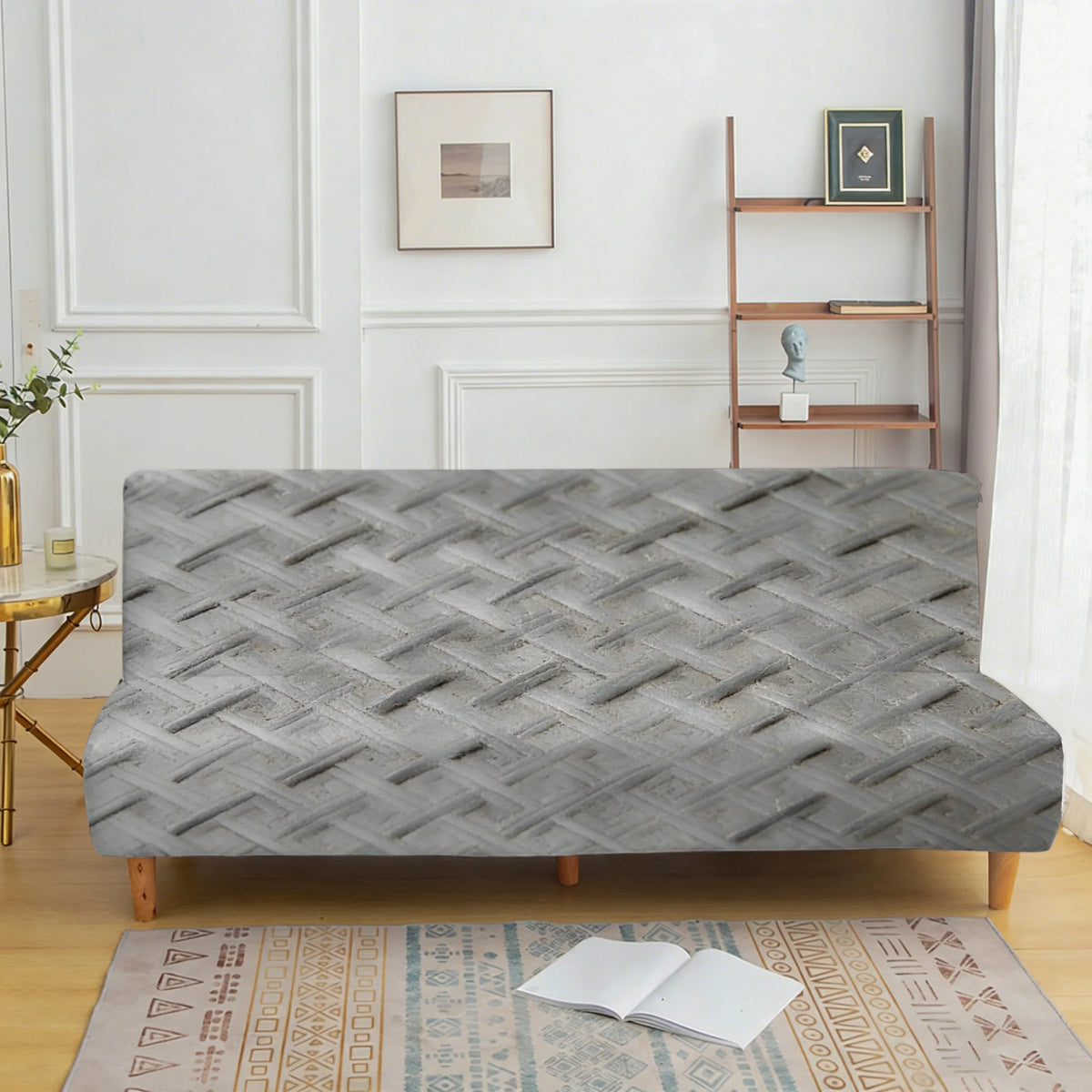 A gray velvet non-slip armless sofa cover displayed on a wooden floor with a patterned rug.