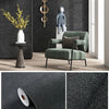 A close-up of self-adhesive 3D thermal insulation wallpaper with a linen texture in dark gray.