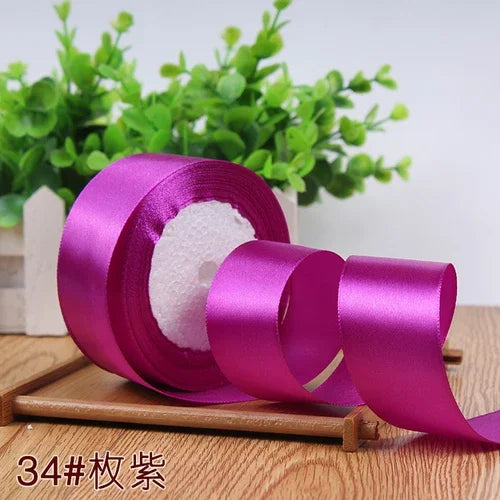 Roll of vibrant purple satin ribbon for gift wrapping and DIY crafts