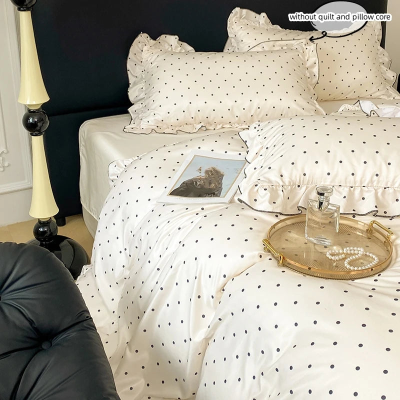 A white Korean lace duvet cover set with black polka dots displayed on a bed.