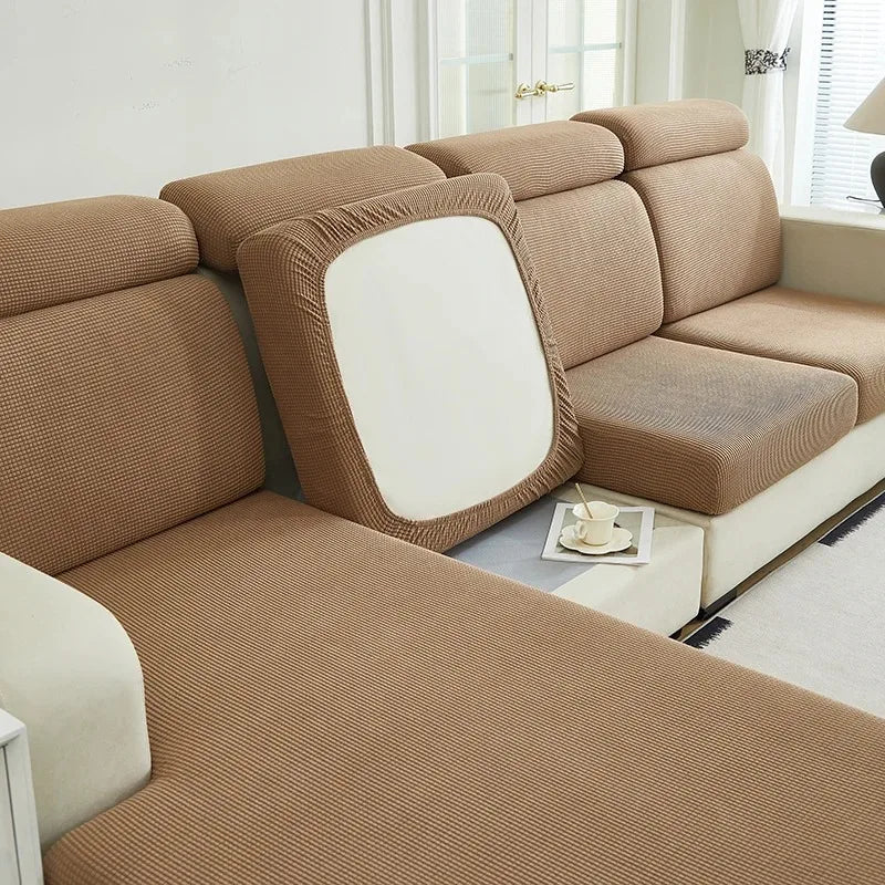A beige jacquard elastic sofa cushion slipcover with a light cream accent and decorative piping.