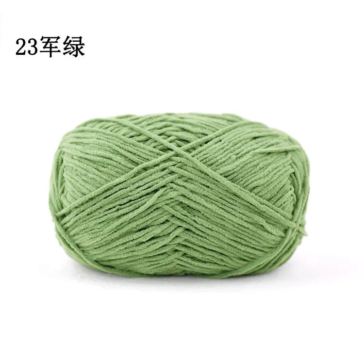 A ball of light green chenille yarn used for knitting and crochet projects.