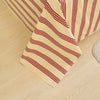 A close-up of beige and burgundy striped organic cotton bedding, showing a flat sheet and pillowcase.