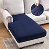 Navy blue jacquard stretch sofa cushion covers placed on a light gray sofa.