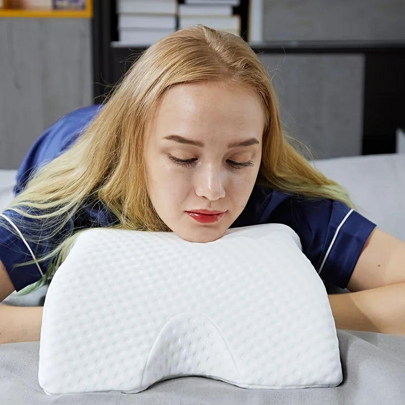 A young woman is using an arched white memory foam pillow for body and neck support.