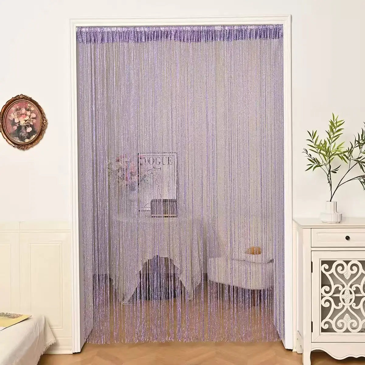 Purple beaded string curtains hanging in a doorway, used for home or party decor.