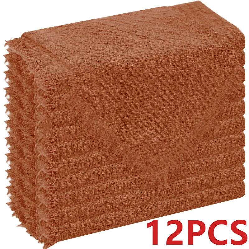A stack of rust-colored, fluffy decorative cloth napkins.