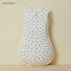 White cotton sleep sack with a pattern of blue triangles for baby and toddler