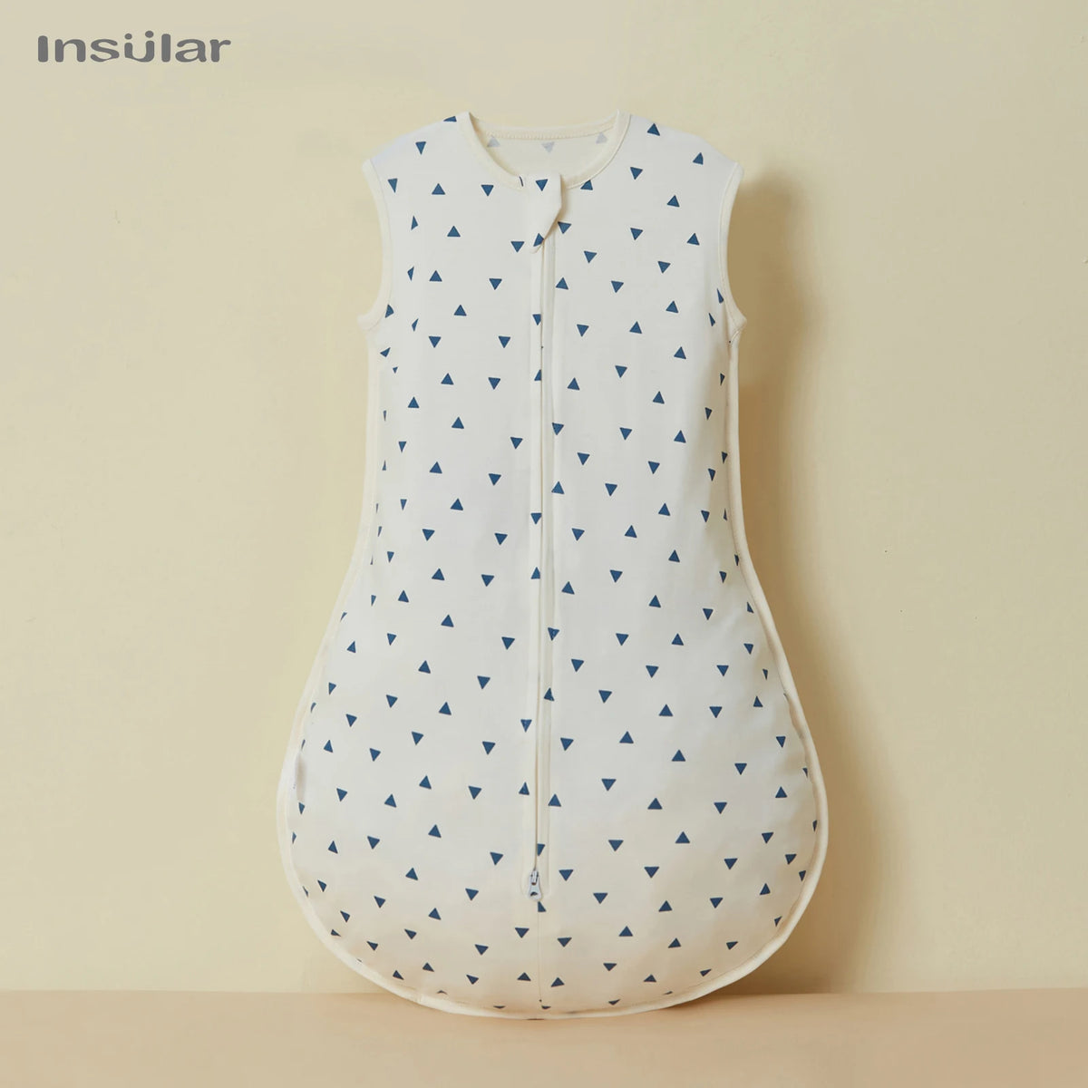 White cotton sleep sack with a pattern of blue triangles for baby and toddler