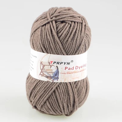 A ball of taupe colored TPRPYN Pad Dyeing yarn for knitting