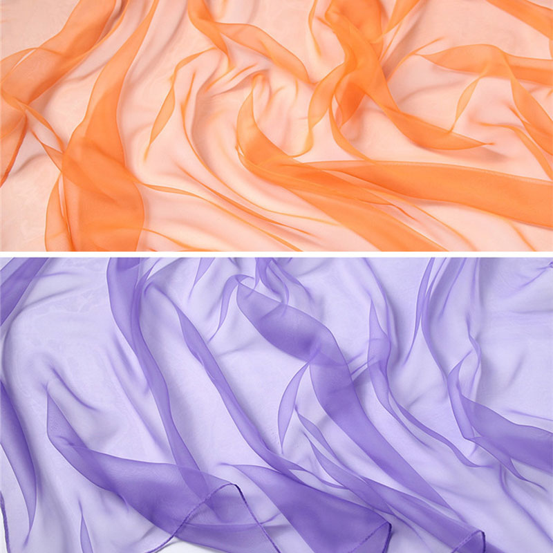 Flowing sheer scarves in shades of orange and purple for sensory play